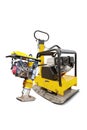 The vibratory plate and hand rammer are shown separately and are suitable for rental use in construction projects. Equipment for Royalty Free Stock Photo