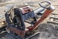 Vibratory rammer with vibrating plate on a construction site. Compaction of soil for further construction work. Close-up Royalty Free Stock Photo