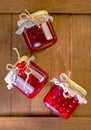 viburnum jam. Red juicy berries of a viburnum with sugar in a glass jar on a dark wooden background. For making jam, tea Royalty Free Stock Photo