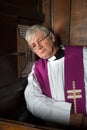 Vicar in confession booth