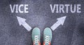 Vice and virtue as different choices in life - pictured as words Vice, virtue on a road to symbolize making decision and picking