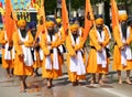Vicenza, VI, Italy - April 8, 2017: Men with turbans Sikh Religious procession with scimitars and orange flags Royalty Free Stock Photo
