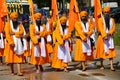 Vicenza, VI, Italy - April 8, 2017: Men with turbans Sikh Religious procession with ceremonial scimitars and orange flags Royalty Free Stock Photo