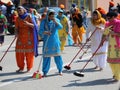 Vicenza, Vi, Italy - April 8, 2017: women Sikh religious ceremony sweep the street with brooms during the Nagar Kirtan festival