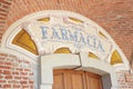 Arcade in red bricks around Sanctuary of Vicoforte church, ancient pharmacy sign in Italy Royalty Free Stock Photo