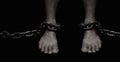 Victim, Slave, Prisoner male foor tied by big metal chain. People have no freedom concept image.