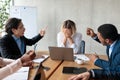 Colleagues Shouting At Unhappy Victimized Businesswoman Sitting In Modern Office Royalty Free Stock Photo