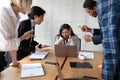 Victimized Businesswoman Covering Ears Not Listening To Aggressive Colleagues Indoor Royalty Free Stock Photo