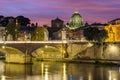 Victor Emmanuel bridge over Tiber river with St. Peter`s cathedral dome in Vatican at night, Rome, Italy Royalty Free Stock Photo