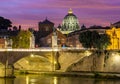 Victor Emmanuel bridge over Tiber river with St. Peter\'s cathedral dome in Vatican at night, Rome, Italy Royalty Free Stock Photo