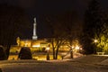 Victor statue on Kalemegdan fortress seen from the Kalemegdan park during a cold winter evening, covered in snow. Royalty Free Stock Photo