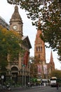 Classic and historic stone City Hall clock tower, St Paul`s Cathedral bell towers and tram in Melbourne cbd, Victoria, Australia