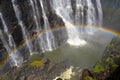 Victoria Falls with rainbow on Zambezi river, falling water from rock, view from Zambia, Africa Royalty Free Stock Photo