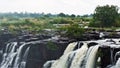 Victoria Falls. The rocky bed of the Zambezi River breaks off and water flows into the abyss Royalty Free Stock Photo