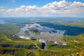 Victoria Falls between Zimbabwe and Zambia, aerial photo of helicopter, green forest around huge waterfalls Royalty Free Stock Photo