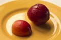 Victoria plum on a yellow plate