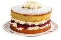 Victoria sponge cake layered with jam and cream displayed on a white dish