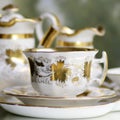 Victorian antique porcelain coffee cup in gold and white Royalty Free Stock Photo