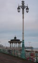 Victorian bandstand on the promenade in Brighton, East Sussex, UK, with lamp post in the foreground. Photographed at dusk Royalty Free Stock Photo