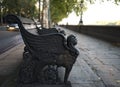 Victorian bench on the sidewalk footpath of the River Thames. Autumn cityscape