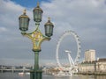 Victorian and classical lamppost detailed with London Eye on background Royalty Free Stock Photo