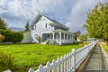 A Victorian cottage with a white picket fence and covered front porch and deck in the Spokane, Washington area of the U.S. Royalty Free Stock Photo