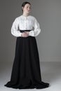 A Victorian or Edwardian woman wearing a white linen garibaldi blouse and black skirt Royalty Free Stock Photo