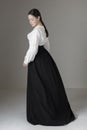 A Victorian or Edwardian woman wearing a white linen garibaldi blouse and black skirt Royalty Free Stock Photo