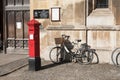 Victorian postbox with bicycle outside Kings College
