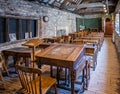 Victorian schoolroom with wooden desks and ink wells in Scaplen`s Court, Poole, Dorset