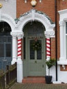 Victorian stained glass door front porch with Christmas decorations Royalty Free Stock Photo