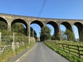 Victorian stone viaduct, set against a blue sky on, Alderscholes Lane, Bradford, UK