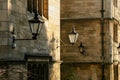 Victorian style street lighting lanterns against Oxford College in afternoon sun