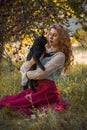 Victorian style, woman at autumn garden with a cat Royalty Free Stock Photo