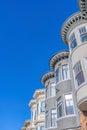 Victorian townhouses with decorative frieze and dentils in a low angle view at San Francisco, CA