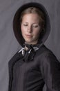 Victorian woman in a black bodice and bonnet