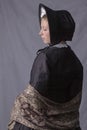 Victorian woman in a black bodice, shawl and bonnet