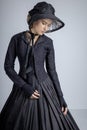 Victorian woman in black ensemble