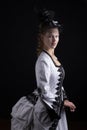 Victorian woman in black and white bustle dress and hat