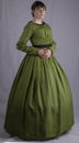 Victorian woman in a green bodice and skirt