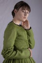 Victorian woman in a green bodice and skirt