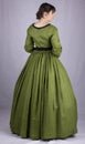 Victorian woman in a green bodice and skirt