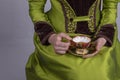 Victorian woman in a green silk outfit drinking a cup of tea Royalty Free Stock Photo