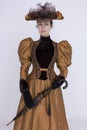 A Victorian woman wearing a bronze and brown silk ensemble Royalty Free Stock Photo