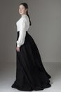 A Victorian or Edwardian woman wearing a white linen garibaldi blouse and black skirt Royalty Free Stock Photo