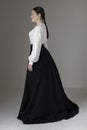 A Victorian or Edwardian woman wearing a white linen garibaldi blouse and black skirt Royalty Free Stock Photo