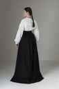 A Victorian or Edwardian woman wearing a white linen garibaldi blouse and black skirt Royalty Free Stock Photo