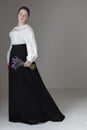 A Victorian or Edwardian woman wearing a white linen garibaldi blouse and black skirt Royalty Free Stock Photo