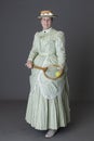 A Victorian Woman Wearing A Tennis Ensemble And A Straw Boater