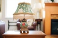 victorianstyle lamp with tasseled shade on side table Royalty Free Stock Photo